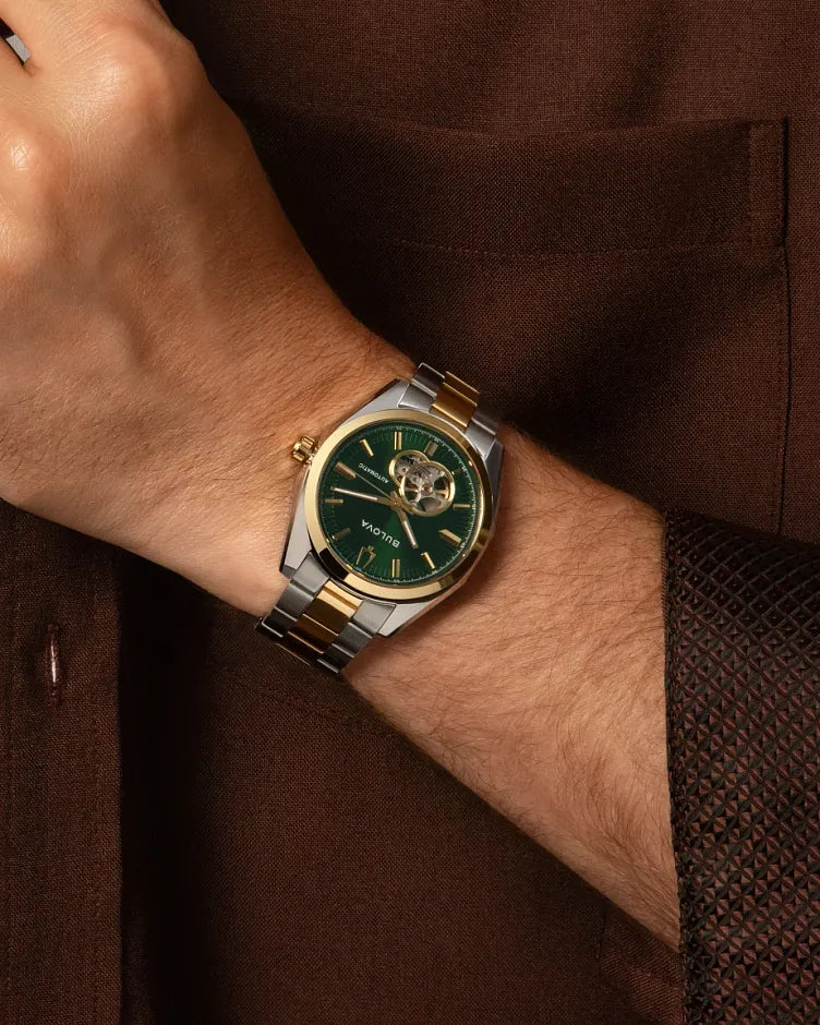 Bulova Surveyor 98A338 automatic men's watch with green open-heart dial and two-tone stainless steel bracelet — caseback view