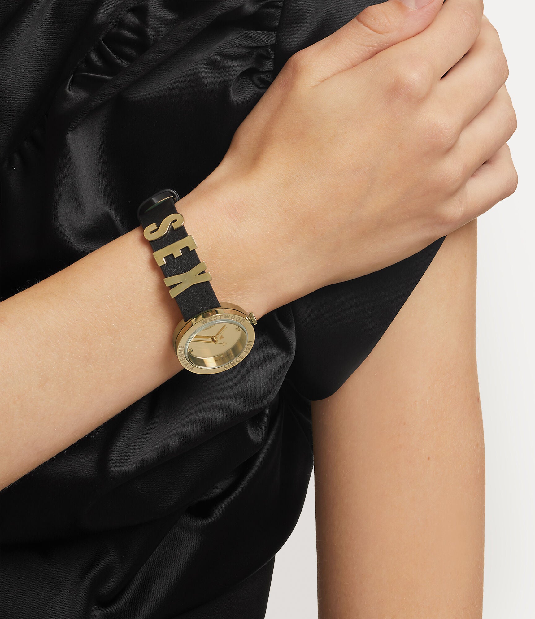 Vivienne Westwood The Rebel women's watch with a gold dial and black leather strap. Shown at an angle.