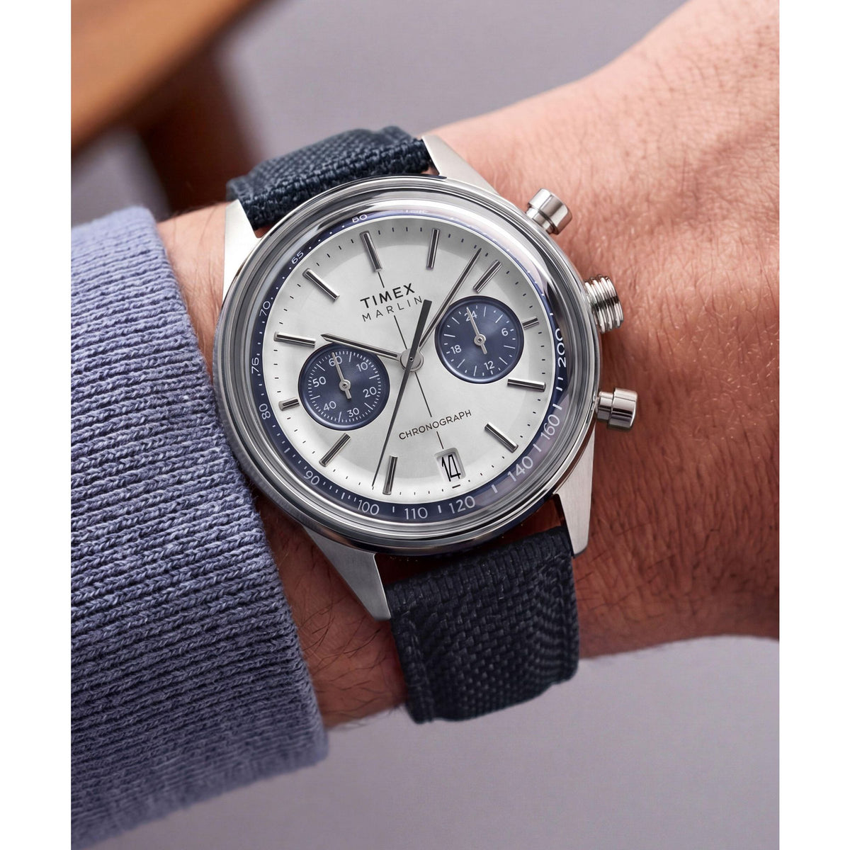 Timex Marlin Jet Chronograph TW2Y89900 silver sunray dial on a navy woven strap, worn on the wrist