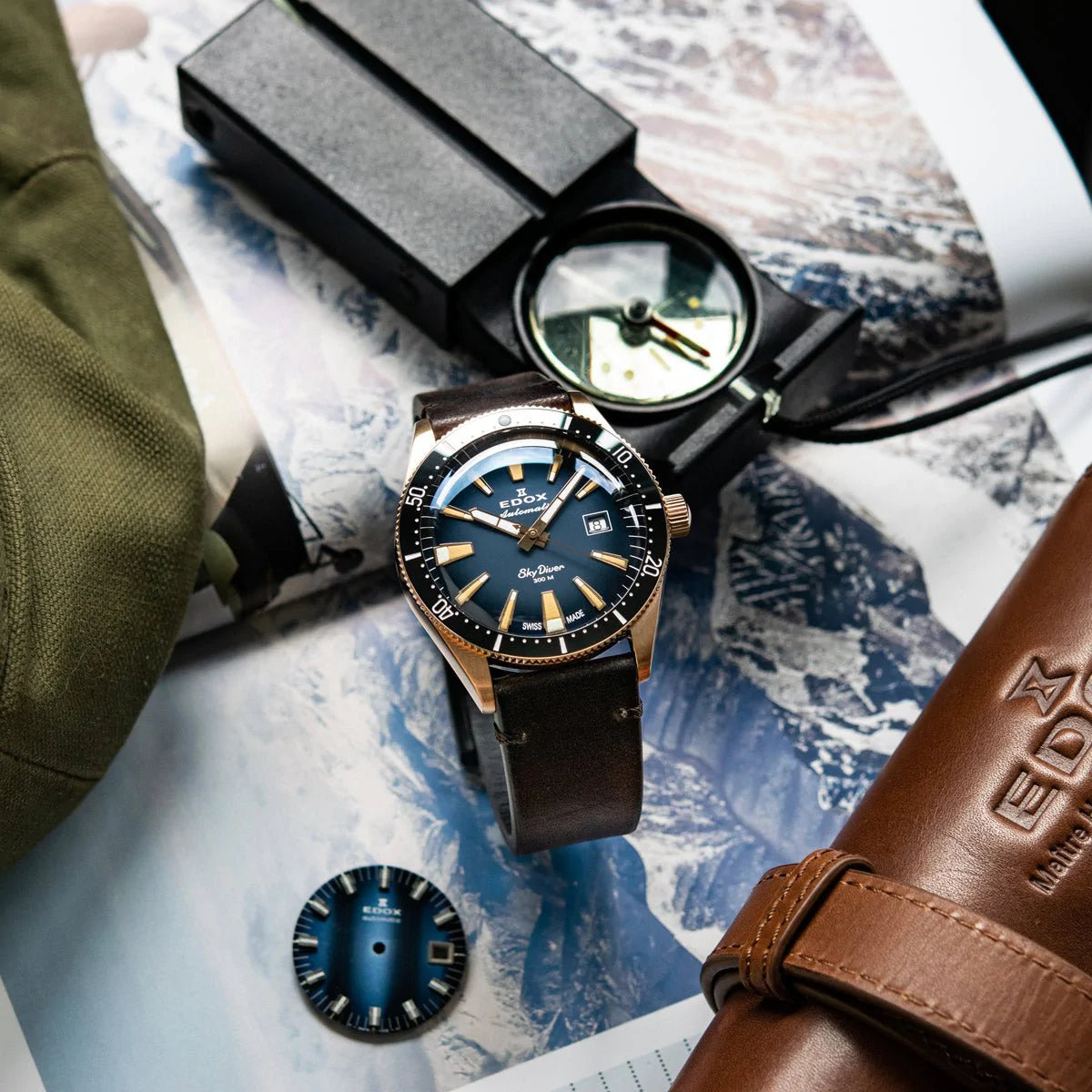 Wristwatch with a blue dial and brown leather strap.