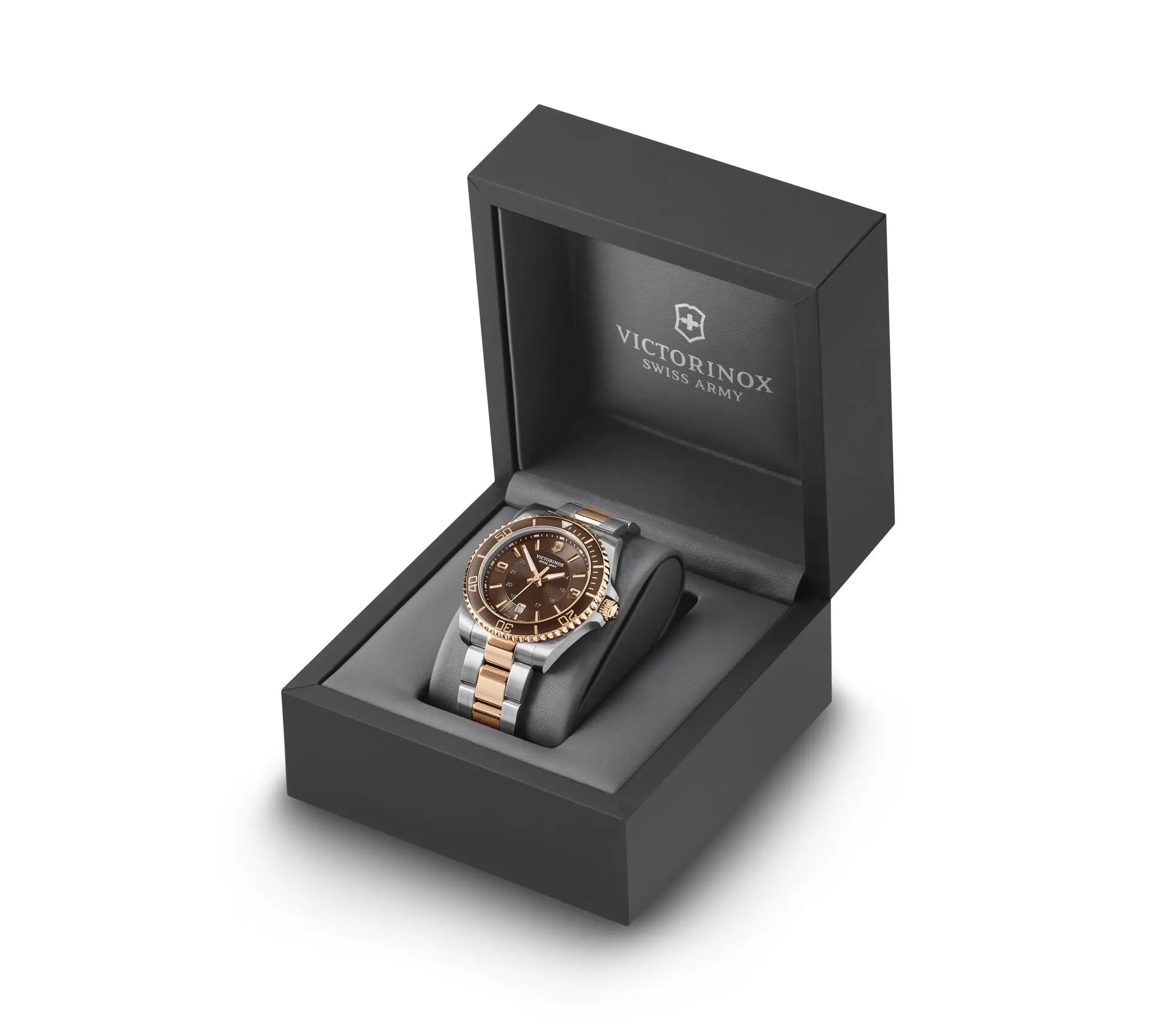 Wristwatch with a brown face and gold-tone band in a Victorinox presentation box.