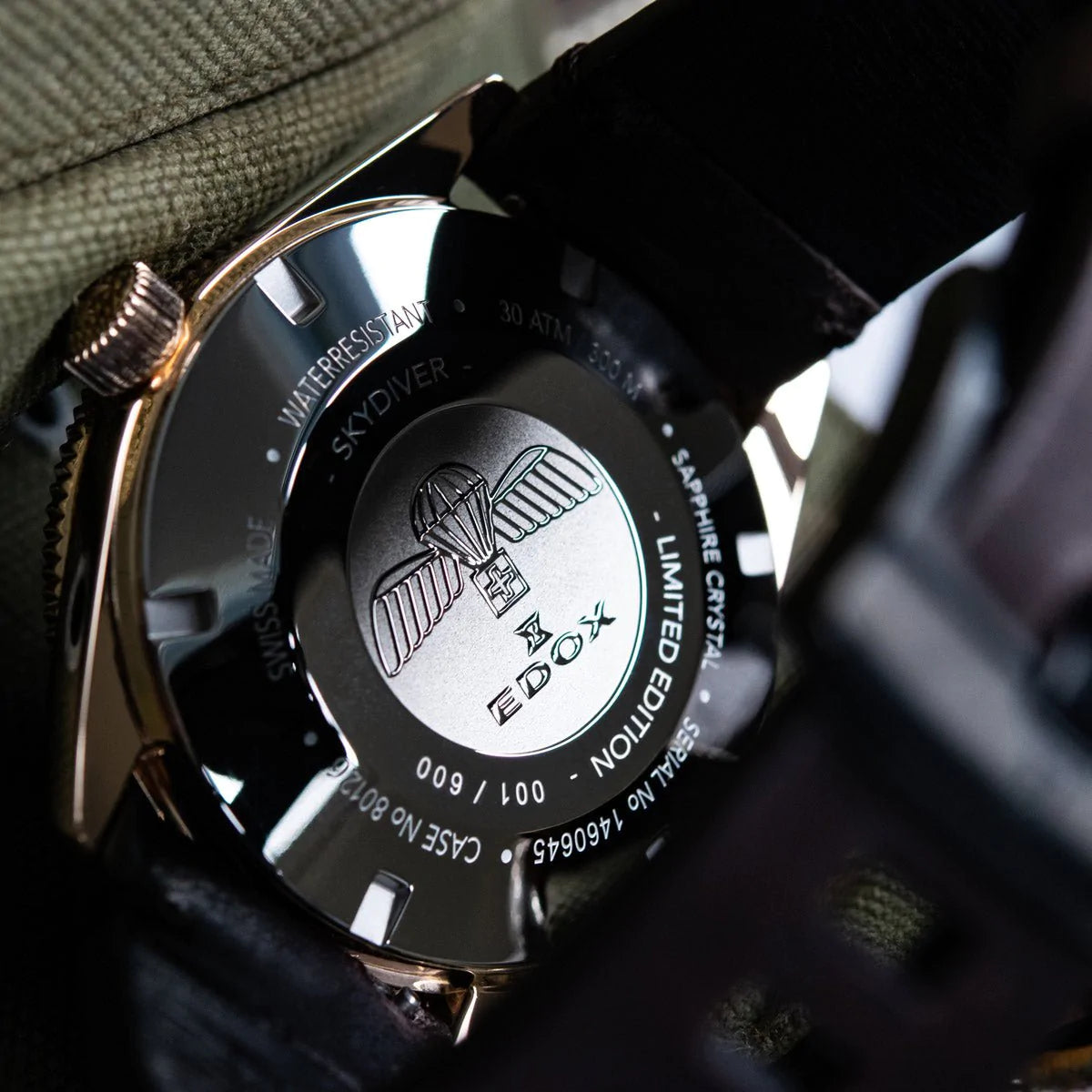Luxury wristwatch with an engraved caseback displaying an eagle logo and limited edition numbering.