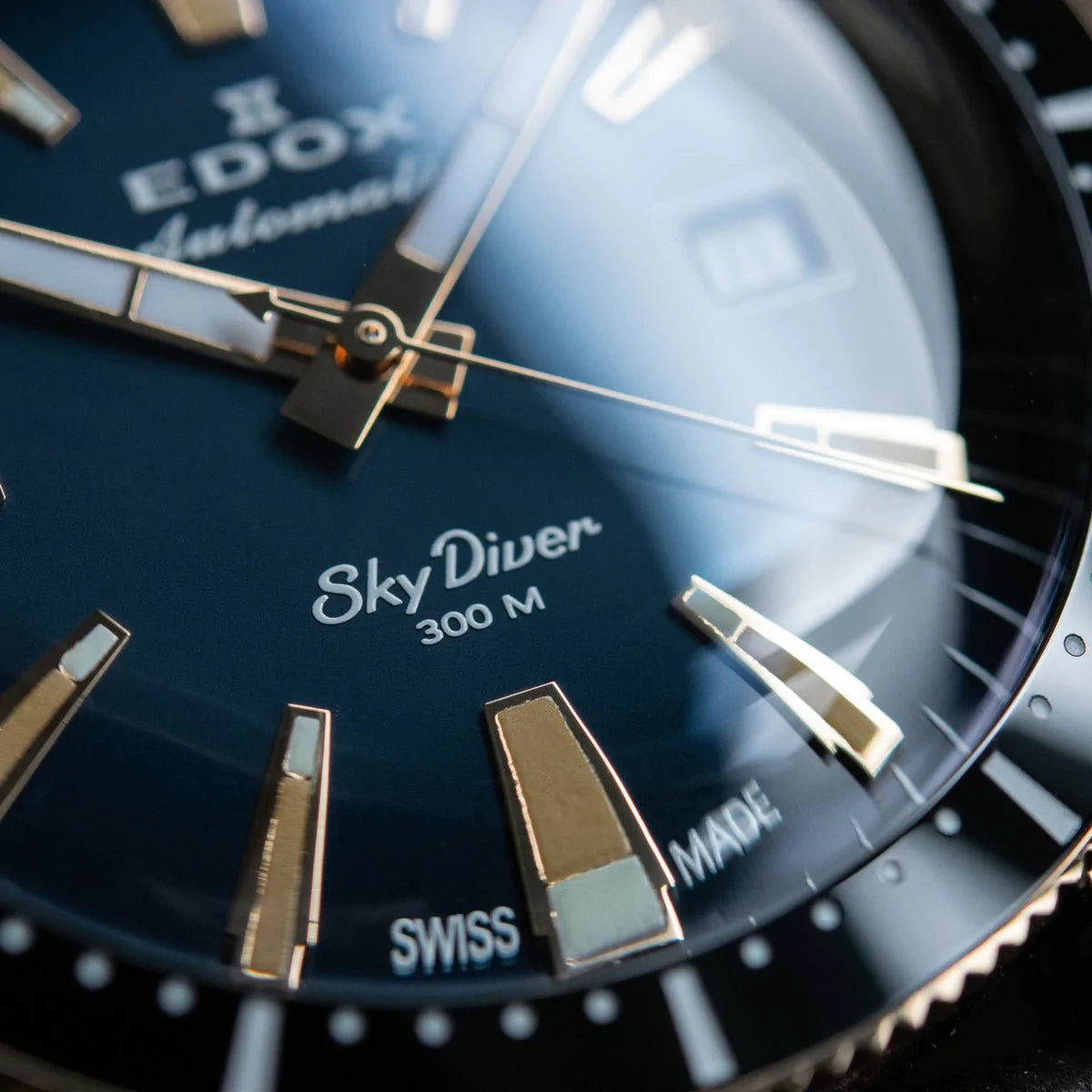 Luxury wristwatch with a blue dial displaying ’SkyDiver 300 M’ and ’Swiss’ markings.