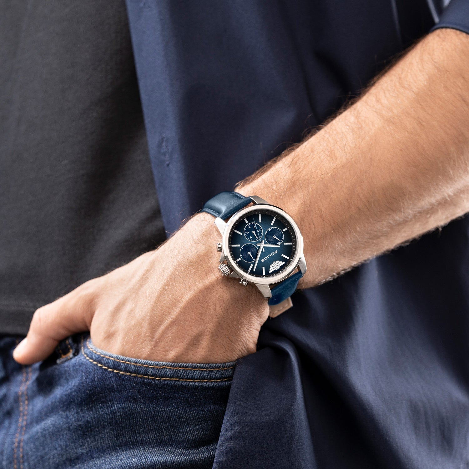 Stylish wristwatch with a blue leather strap and dark face.