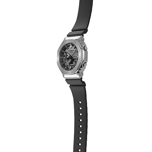 Sleek silver wristwatch with a black rubber strap and a complex dial face.