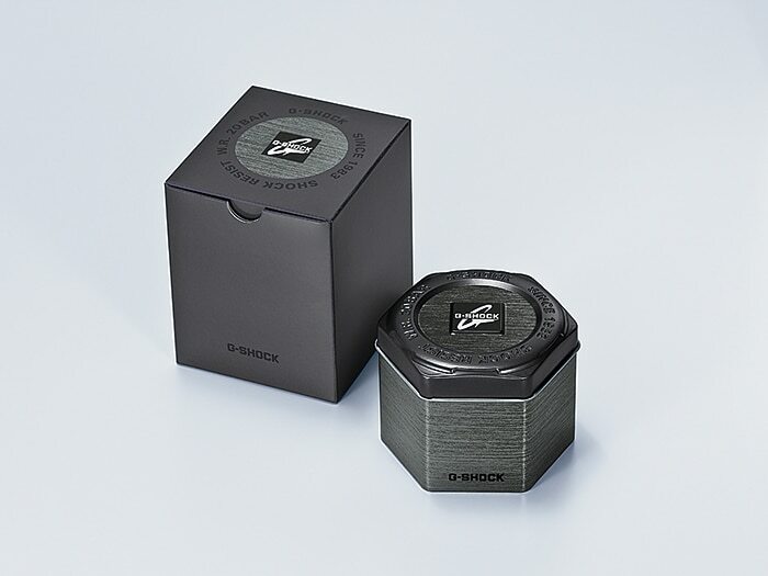 Octagonal metallic watch box with a G-Shock logo on top.