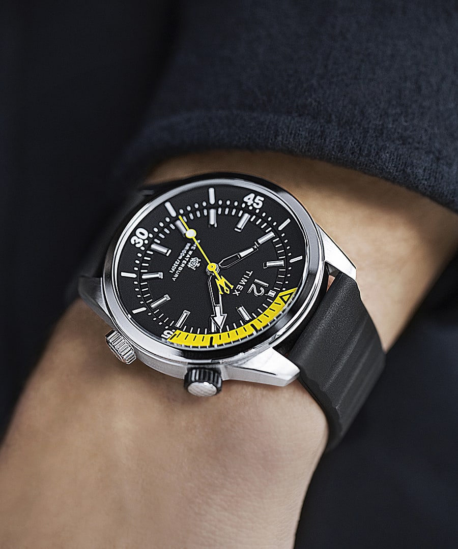 Stylish wristwatch with a black dial and yellow accents on a dark strap.