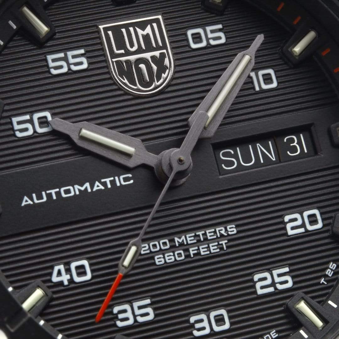 Close-up view of a Luminox watch face showing time, date, and depth rating.
