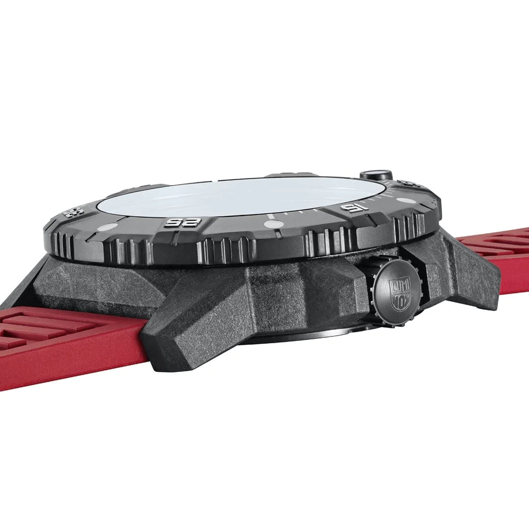 Wristwatch with a black case and red strap viewed from the side.