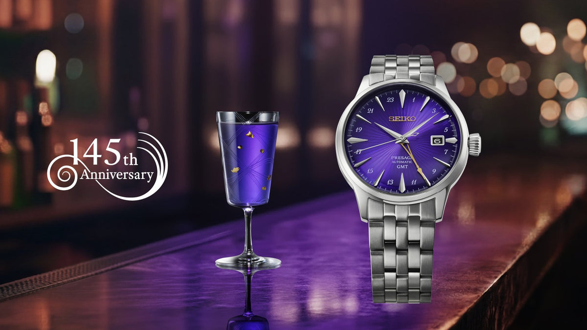 Seiko Presage Cocktail Time HCB006J 145th anniversary limited edition with a purple dial, standing on a bar beside a purple cocktail