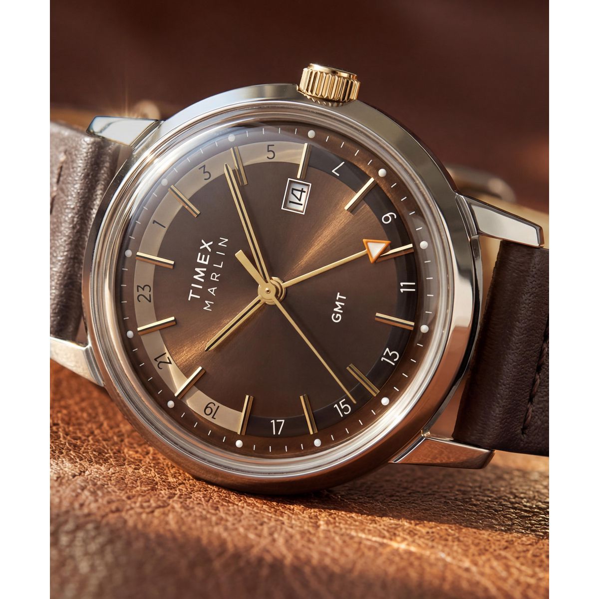 Timex Marlin GMT TW2Y84200 brown leather strap shown flat beside the chocolate brown dial