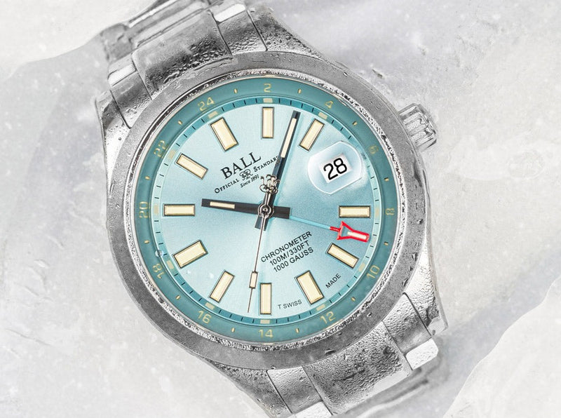 Wristwatch with a light blue dial and silver metal bracelet.