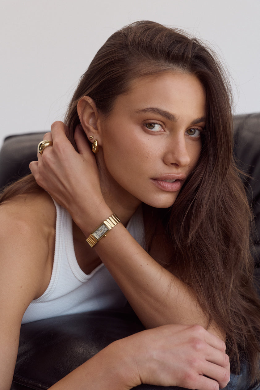 Cendré Enna gold earrings worn on the ear
