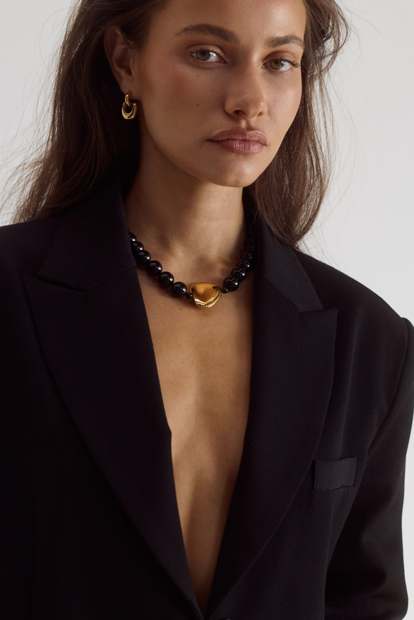 Close-up of the Cendré Plaza sculptural gold pendant