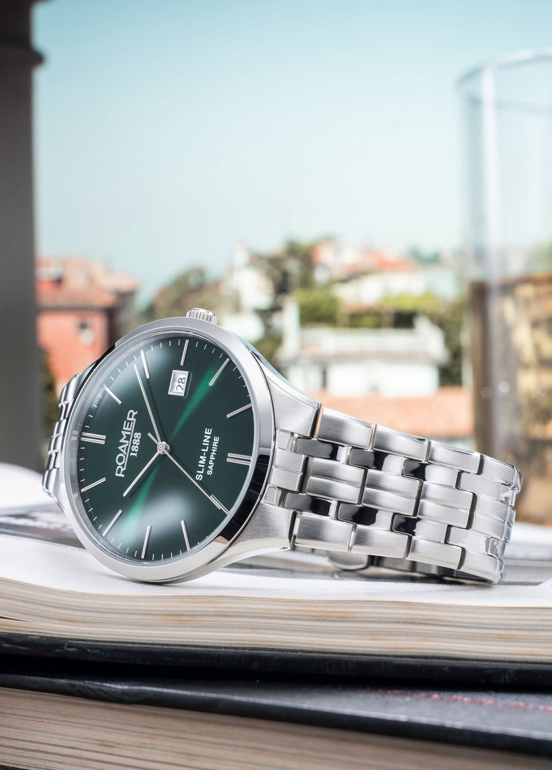 Elegant wristwatch with a green dial and silver metal bracelet.