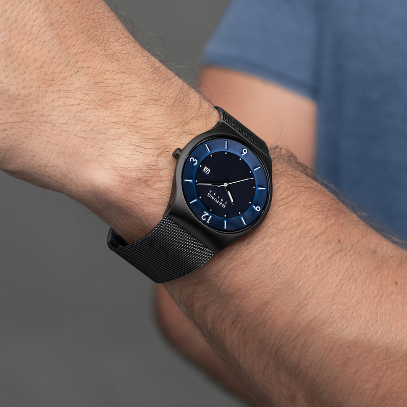 Sleek black smartwatch with a digital display showing the time.