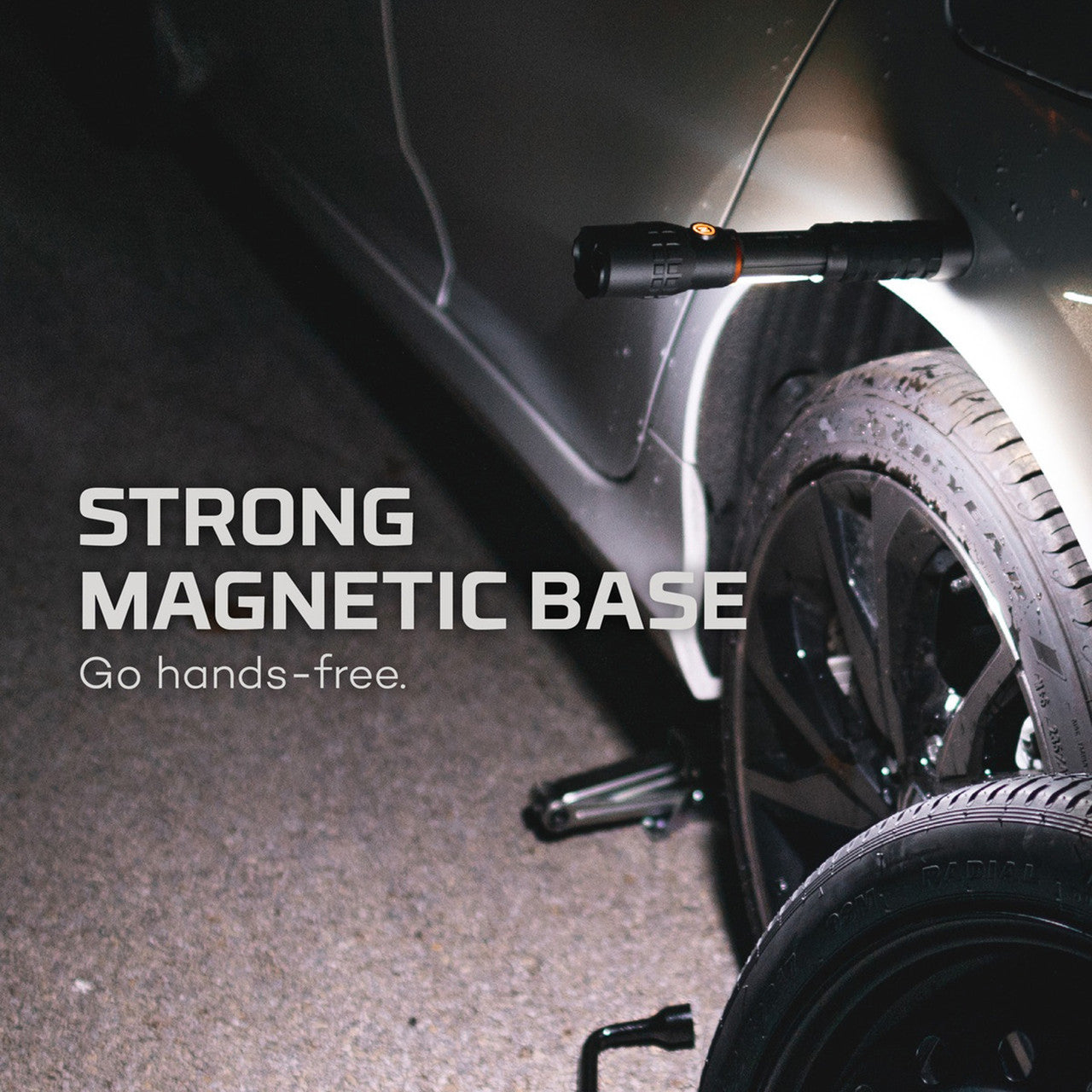 Flashlight with a magnetic base attached to a vehicle’s wheel or tire.
