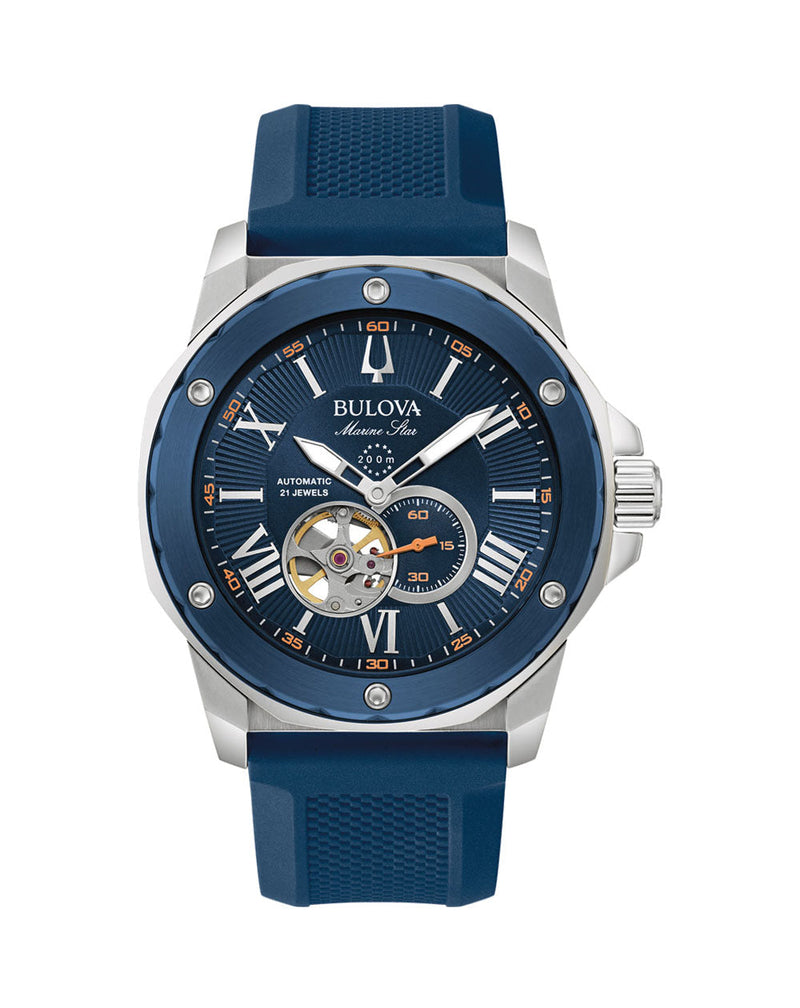 Stylish men’s wristwatch with a blue dial and strap, silver case, and visible mechanical elements.