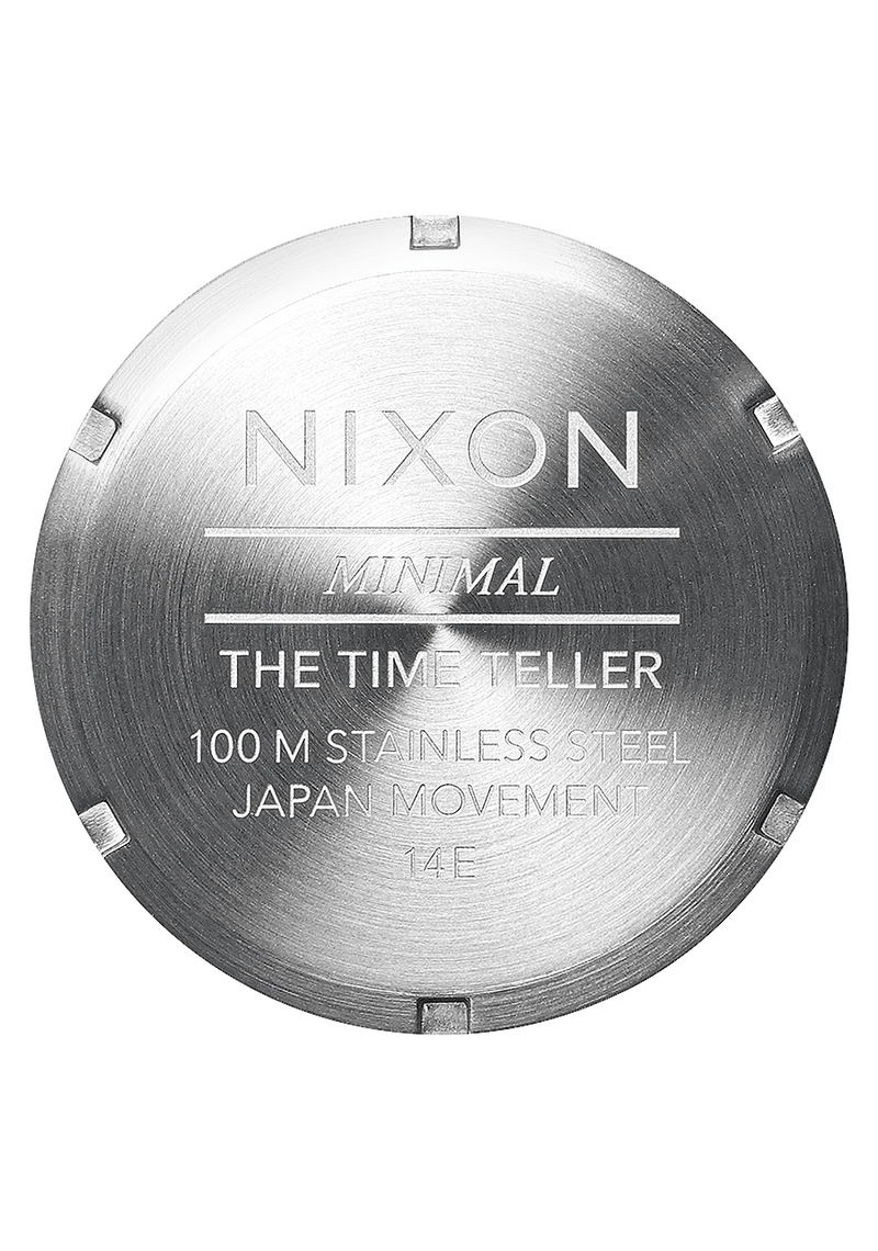 Circular metal watch case back engraved with ’Nixon’ and product details.