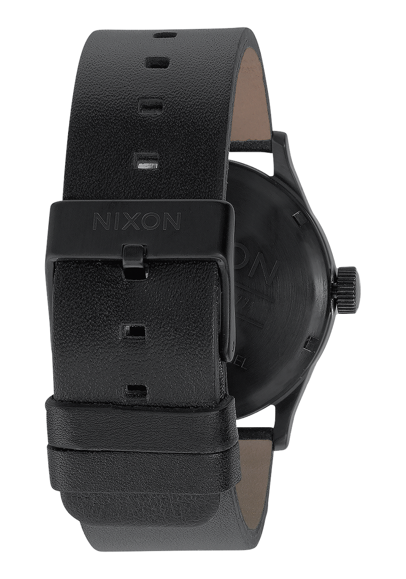 Black leather wristwatch with a minimalist design and ’NIXON’ branding on the strap.
