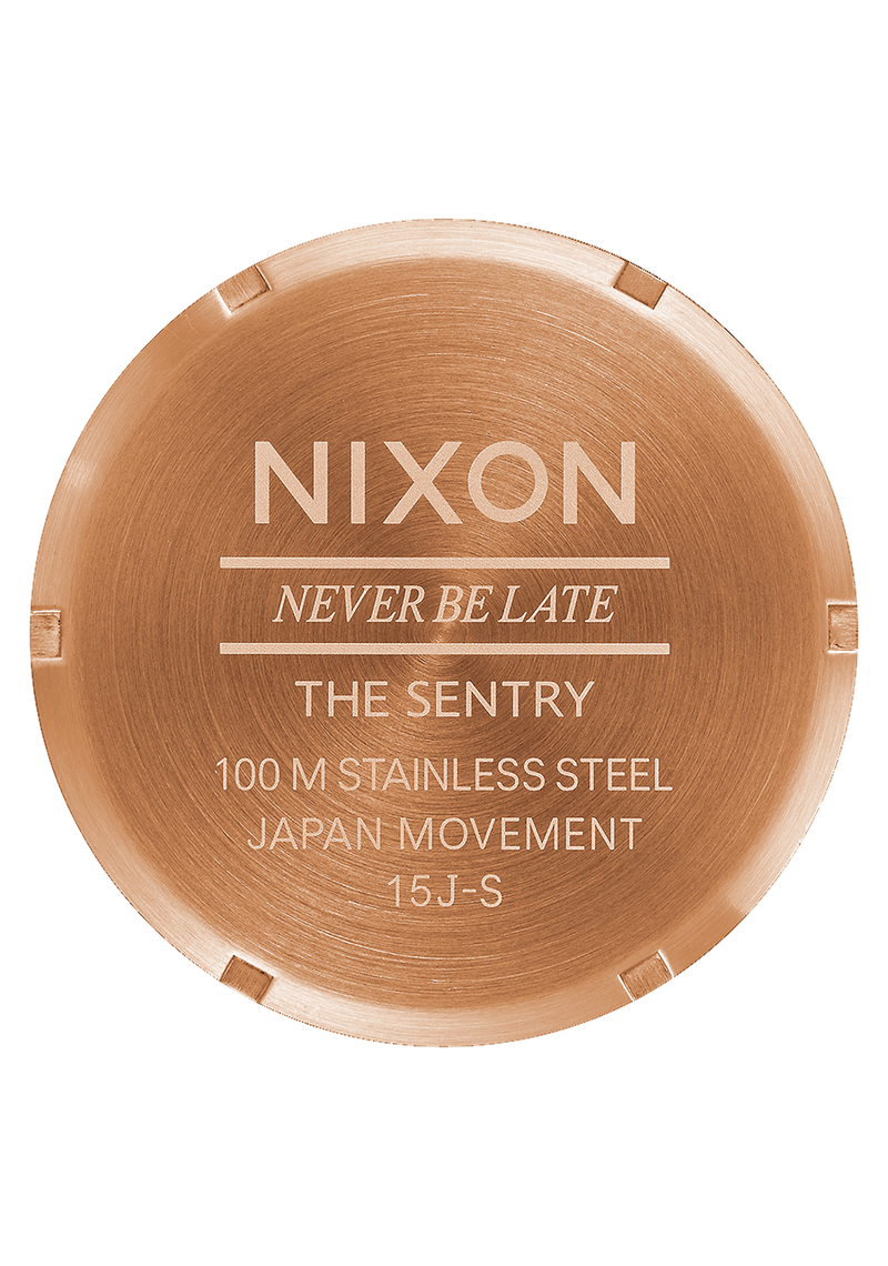 Circular watch case back engraved with ’Nixon’ and product details.