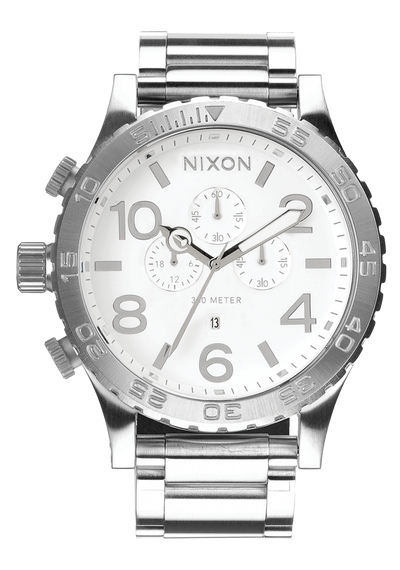 Silver-toned Nixon wristwatch with a white dial and chronograph features.