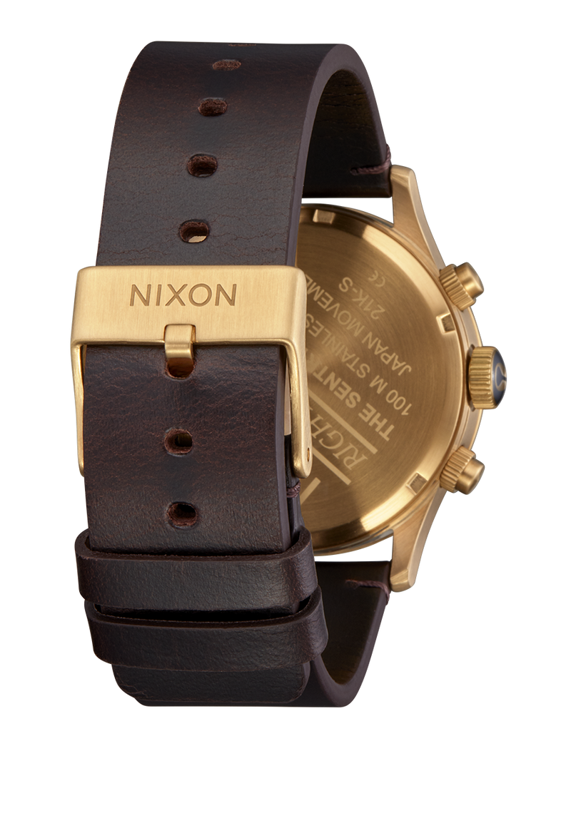 Wristwatch with a gold-toned case and brown leather strap.