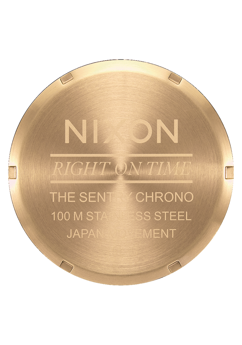 Circular gold-colored watch caseback with engraved text.