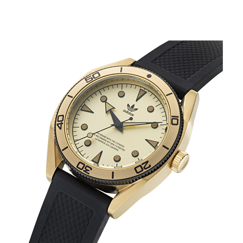 Gold-toned wristwatch with a black rubber strap and beige dial face.