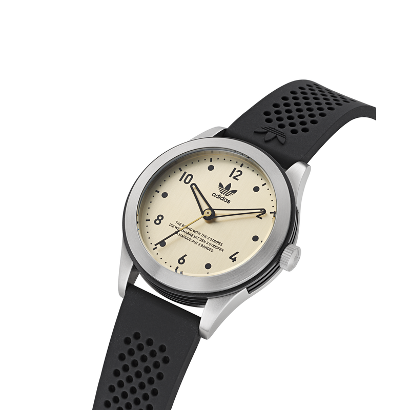 Wristwatch with a cream-colored dial and black perforated strap.