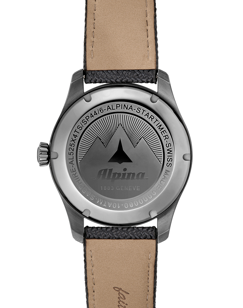 Back of a wristwatch with an engraved mountain logo and leather strap.