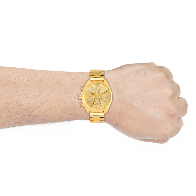 Gold-colored wristwatch with a metal band worn on a person’s wrist.