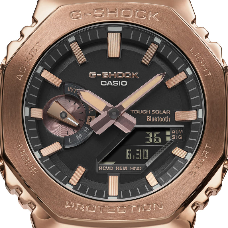 Rose gold G-Shock Casio watch with a black dial and digital display.