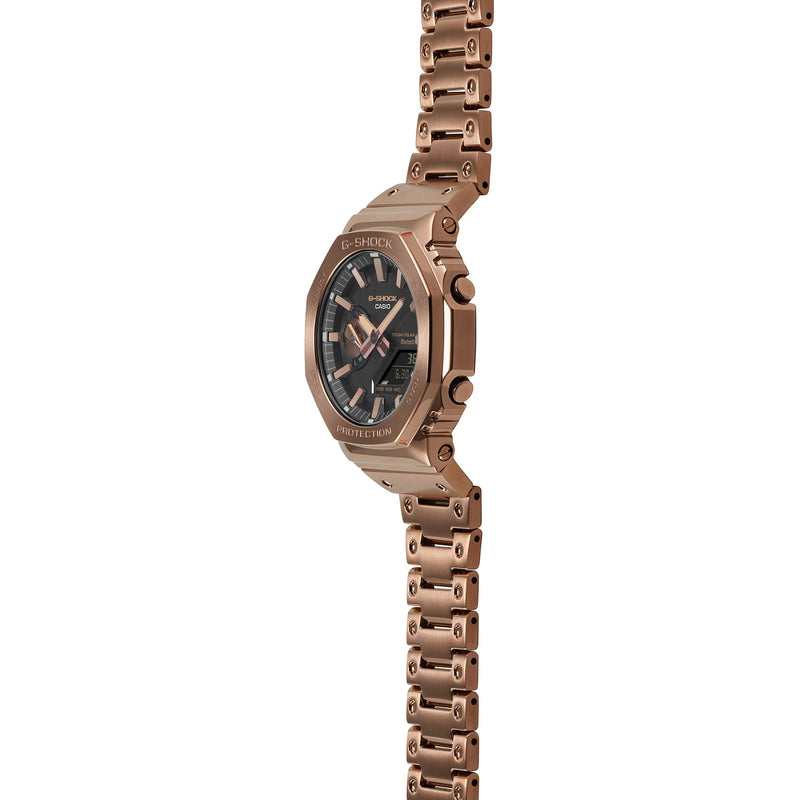 Rose gold wristwatch with a dark face and chronograph subdials.