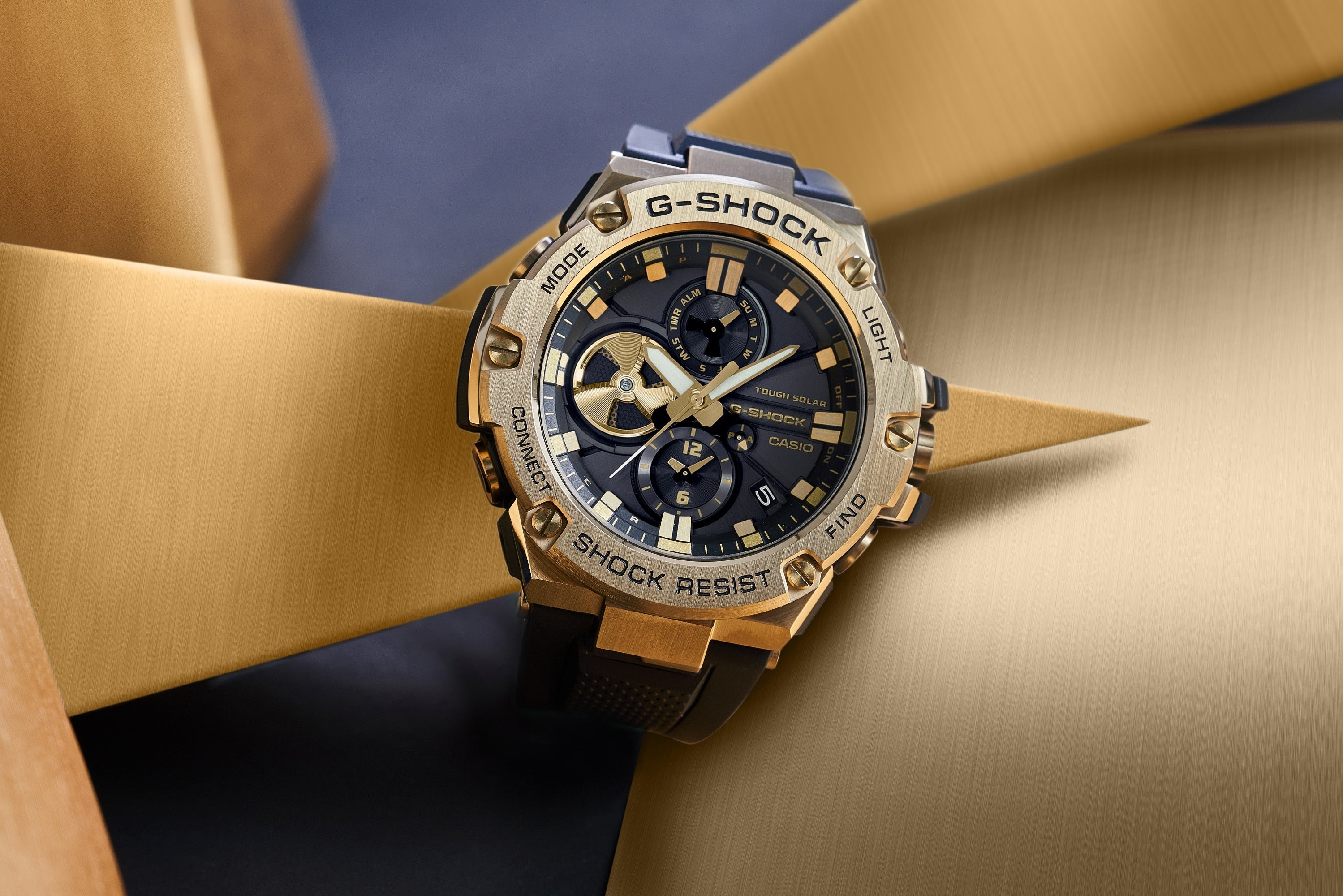 Gold and blue G-Shock wristwatch with multiple dials and a rugged design.