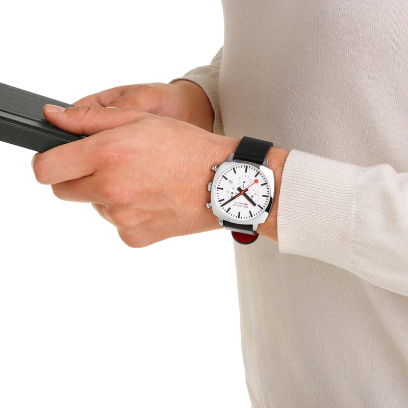 Wristwatch with a white face, red hands, and a black leather strap.