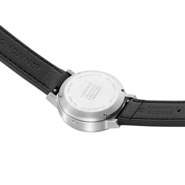 Wristwatch with a black leather strap and silver-colored case back.