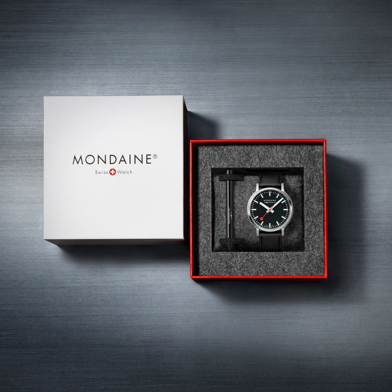 Wristwatch in an open gift box with ’Mondaine’ branding.