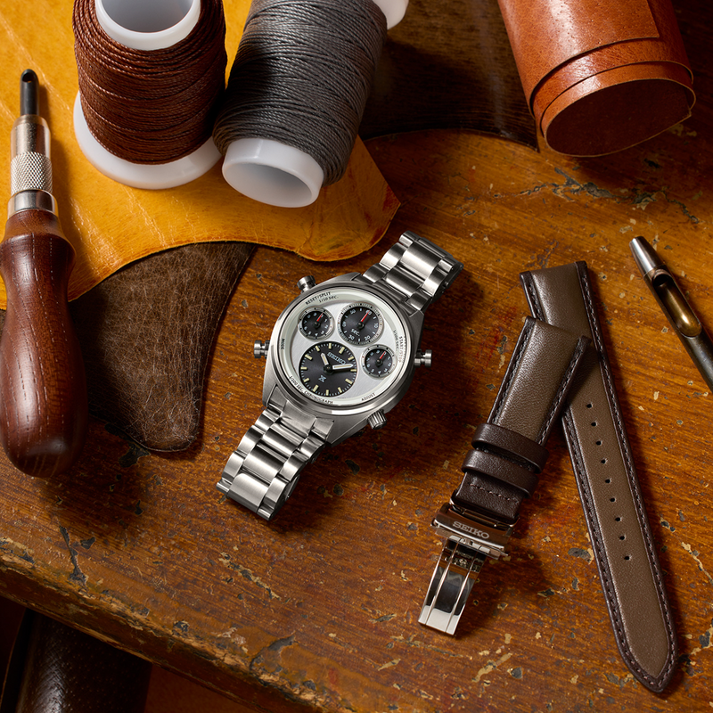 Stainless steel chronograph wristwatch with a white dial and three subdials.