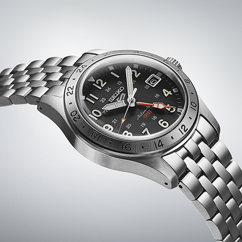Stainless steel wristwatch with a black dial and metal bracelet.