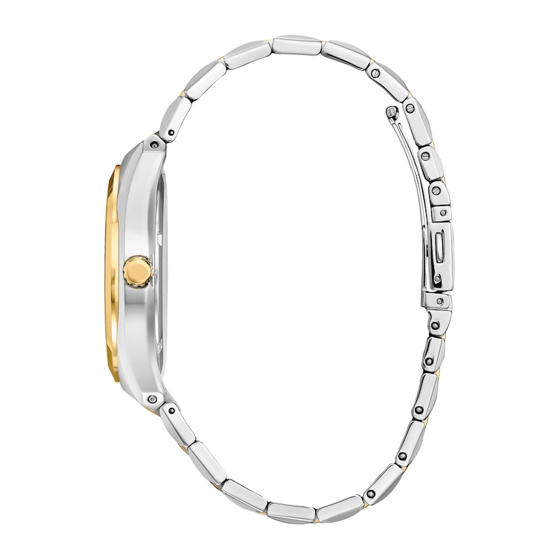 Wristwatch with a silver metal band and gold-accented bezel viewed from the side.