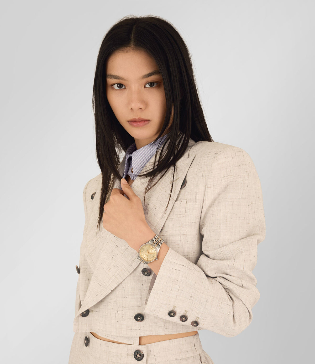 Vivienne Westwood Wallace women's watch with a gold dial and two tone stainless steel bracelet. Shown at an angle.