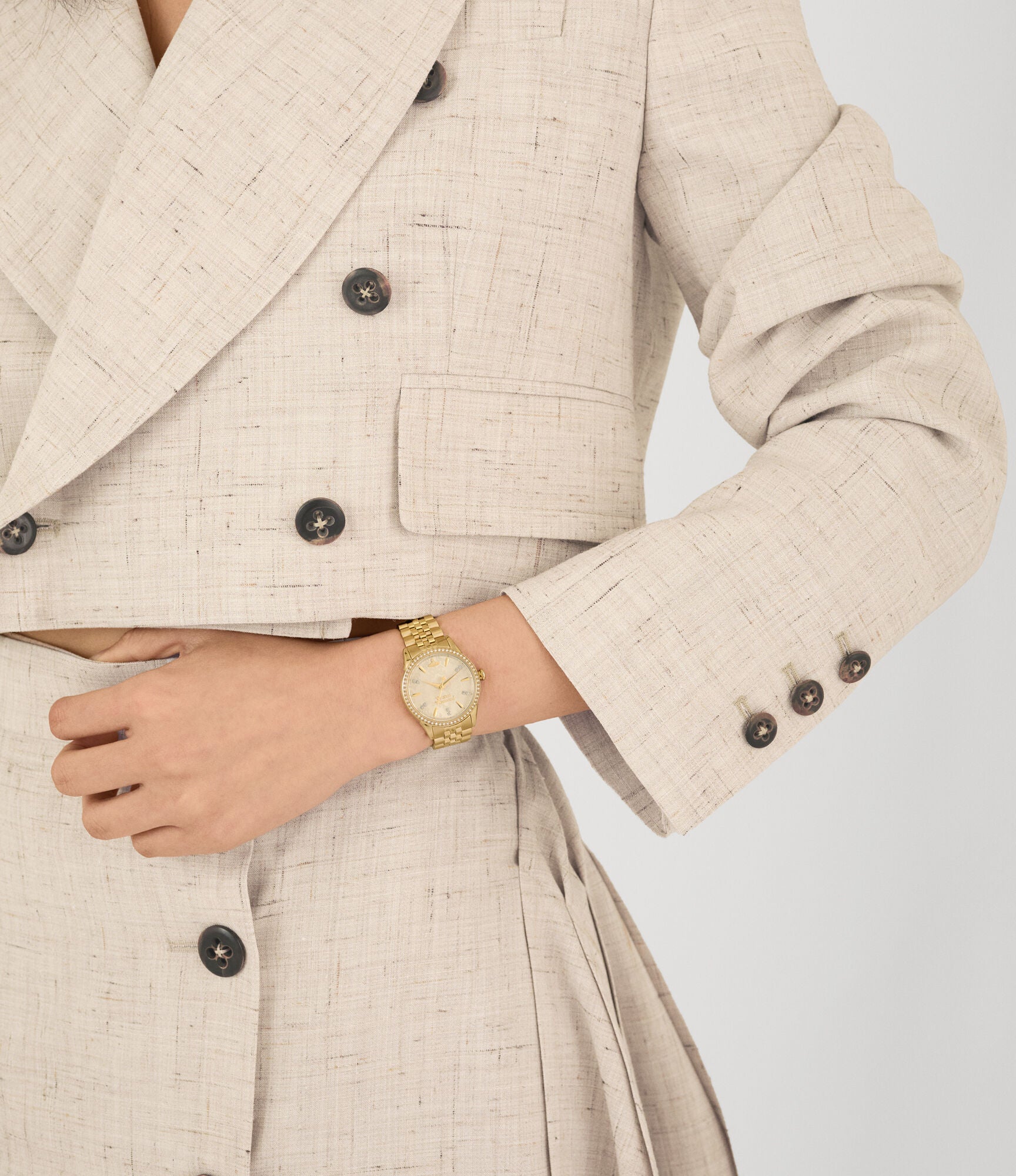 Vivienne Westwood Little Wallace women's watch with a gold dial and gold stainless steel bracelet. Close-up detail view.