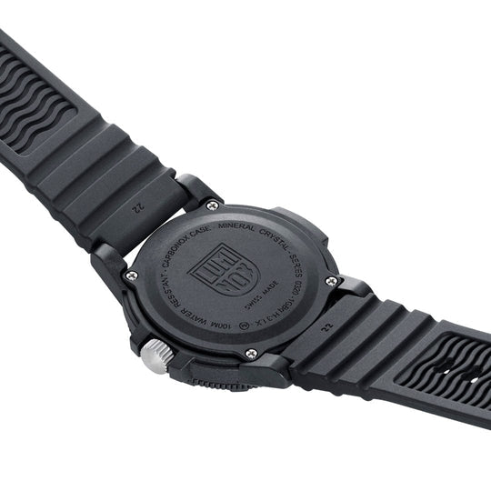 Black wristwatch with a textured rubber strap and a circular face displaying the Luminox logo on the back.