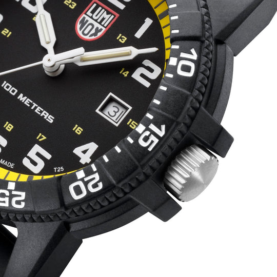 Wristwatch with a black dial and yellow accents showing a close-up of its face and crown.