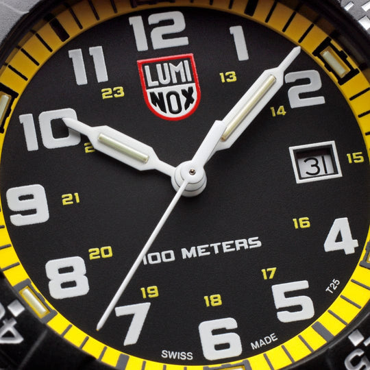 Close-up view of a Luminox watch face with yellow accents and ’100 METERS’ text.