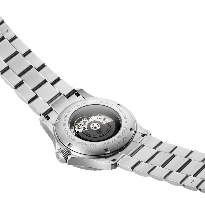 Stainless steel wristwatch with visible mechanical movement through transparent case back.