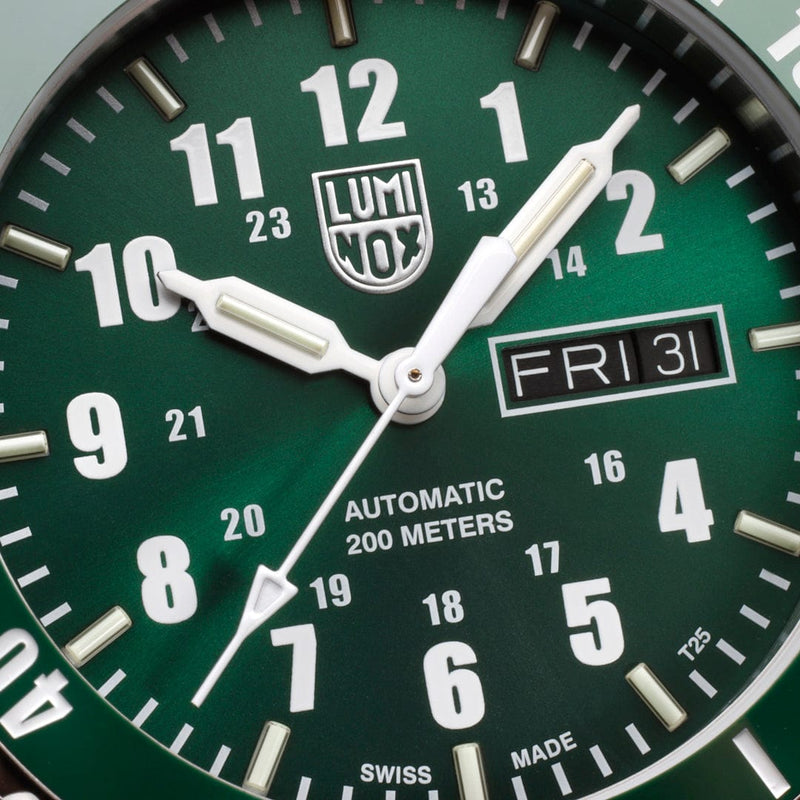 Green-faced analog wristwatch with white hands and markings showing 1:49 on Friday the 31st.