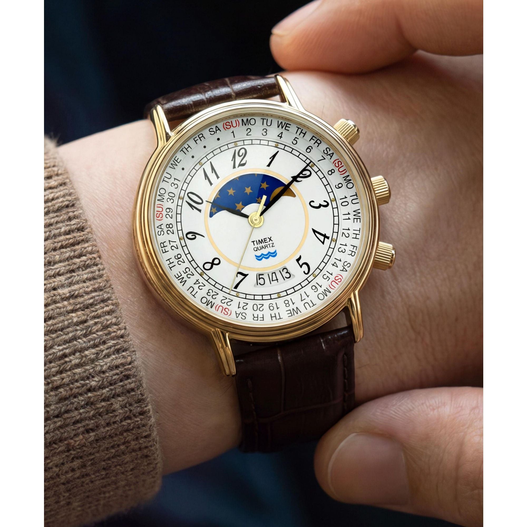 Timex Moon Phase TW2Y99000 white calendar dial with moon phase on a brown leather strap, worn on the wrist