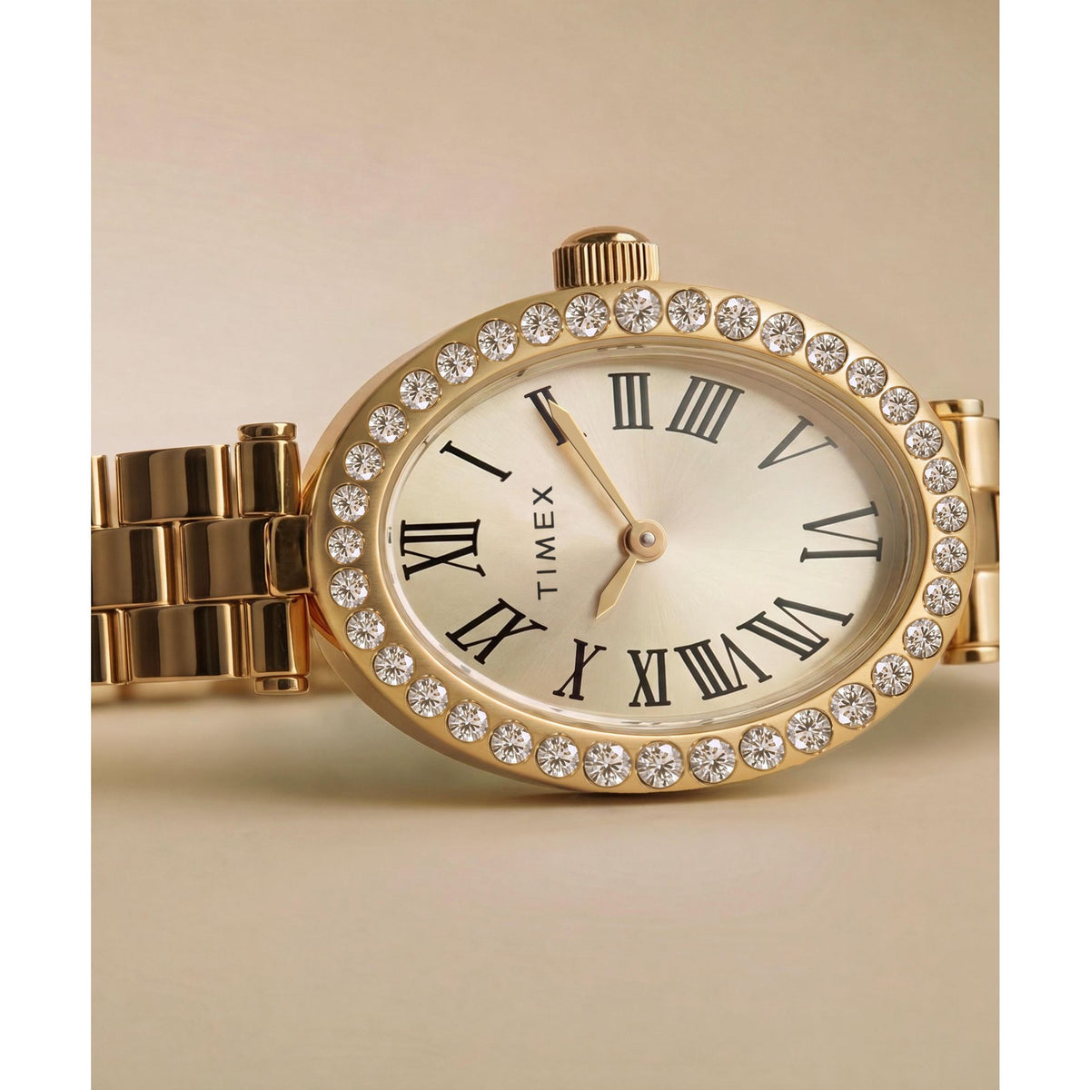 Timex Cavatina TW2Y90100 champagne dial with crystal-set bezel on a gold-tone bracelet, styled detail